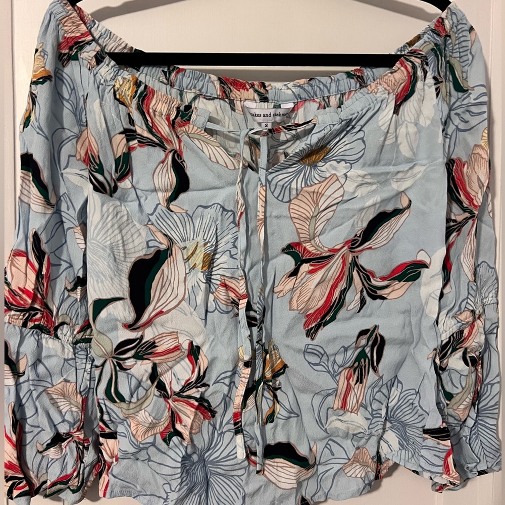 Cupcakes & Cashmere off the shoulder bell sleeve blouse. Light blue with floral